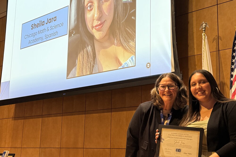 Sheila Jara receiving her award on the ICTFL conference stage 